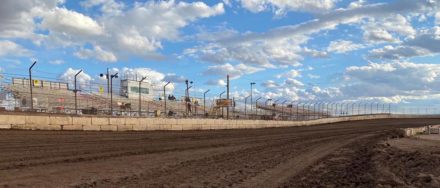 Photo of San Tan Ford’s Arizona Speedway dirt track and grandstands with a blue sky
