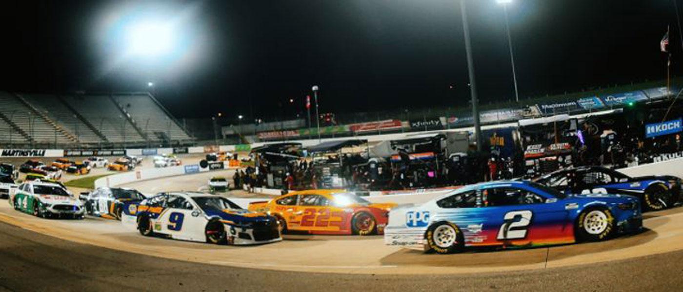 NASCAR race cars turning a corner at Martinsville Speedway