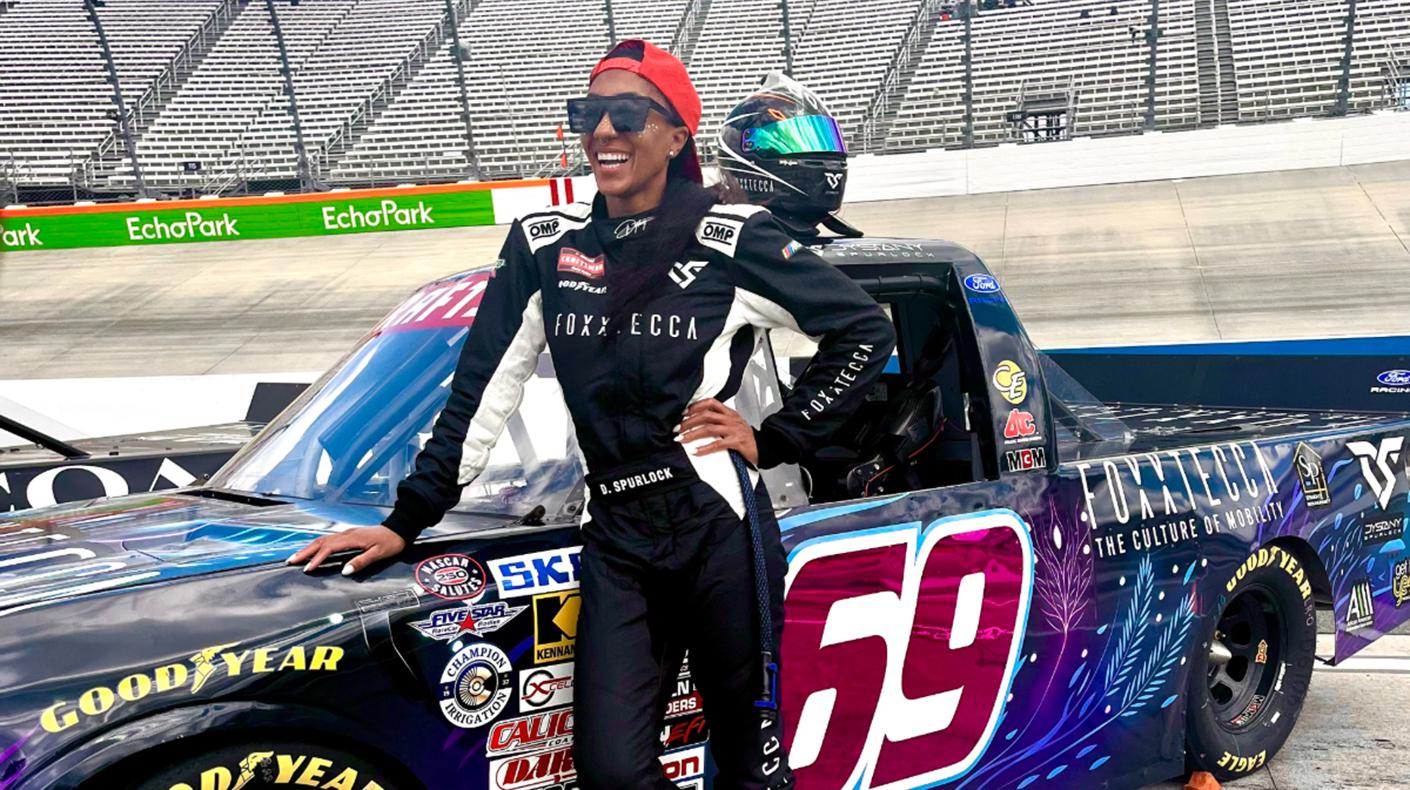 Dystany Spurlock standing next to her NASCAR Craftsman Truck Series car.