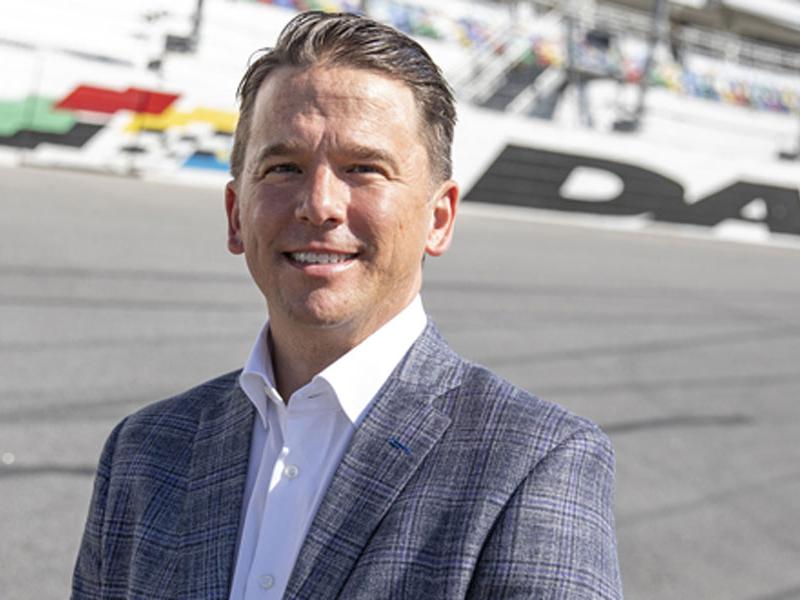 New Daytona International Speedway President Frank Kelleher standing on the race track. Photo courtesy of DIS