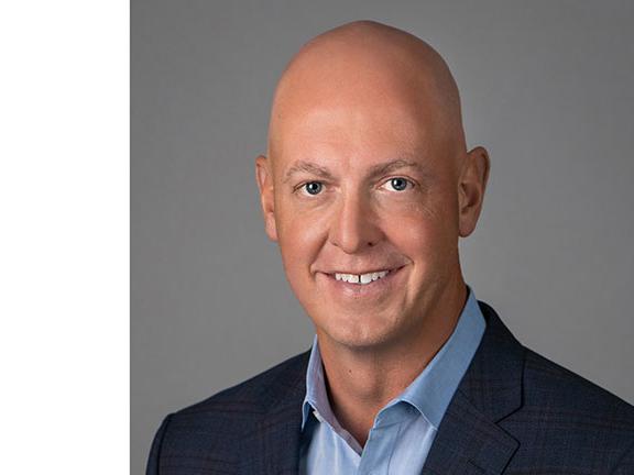 Toyo Tires logo, headshot of John Thomas