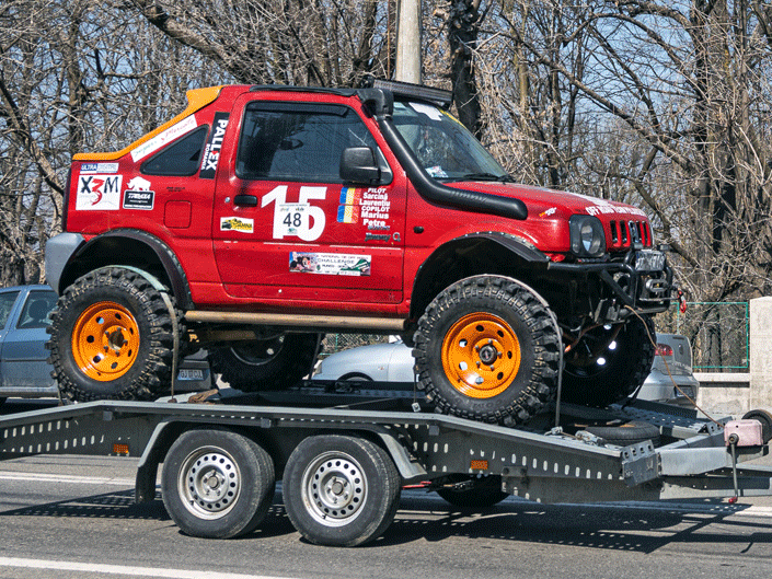 Race car being towed. U.S. Customs Requirements to Bring a Race Car Into the United States