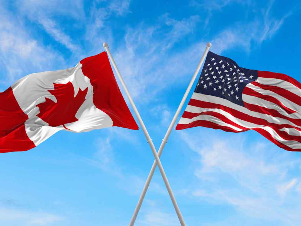 Canadian flag and US flag. Courtesy of Shutterstock