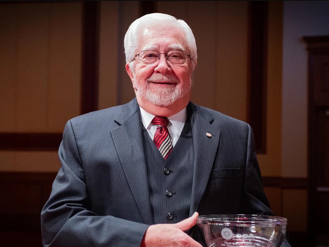 An image of Jerry Wannarka holding a trophy.