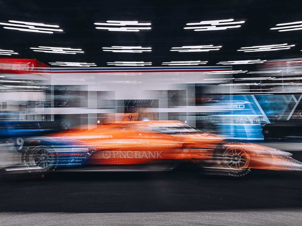 A blurry INDYCAR on the PRI Show floor.