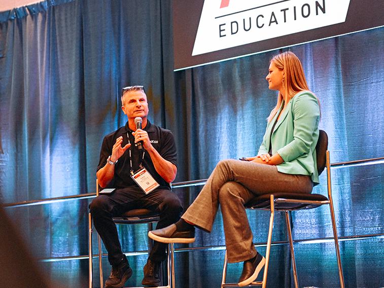 A PRI Education speaker on stage.
