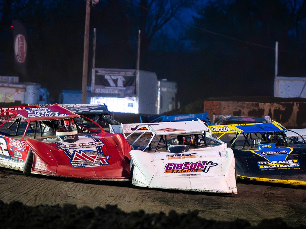 Dirt Late Models on a dirt track.