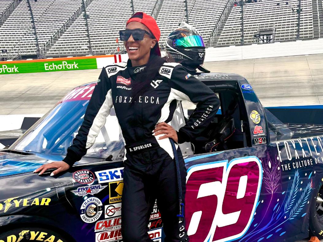 Dystany Spurlock standing next to her NASCAR Craftsman Truck Series car.